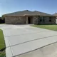 Newly poured concrete driveway in Magnolia, TX finished with a smooth broom texture